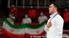 Gold medalist Sajad Ganjzadeh of Iran stands during the medal ceremony for men's kumite 75kg karate at the 2020 Summer Olympics, Saturday, Aug. 7, 2021, in Tokyo, Japan. (AP Photo/Vincent Thian)