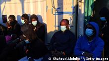 Migrants wearing protective facemasks on board of the humanitarian aid boat Ocean Viking, chartered by charity group SOS Mediterranee, prepare to disimbark upon their arrival on July 6, 2020 in the harbour of Porto Empedocle on the island of Sicily, before being transferred to the Italian ferry Moby Zaza for a quarantine period. - Eleven days after making its first Mediterranean rescues since the coronavirus crisis erupted, the humanitarian aid boat Ocean Viking dropped anchor off the Italian island of Sicily on July 6, 2020, poised to disembark the 180 migrants on board. (Photo by Shahzad ABDUL / AFP) (Photo by SHAHZAD ABDUL/AFP via Getty Images)