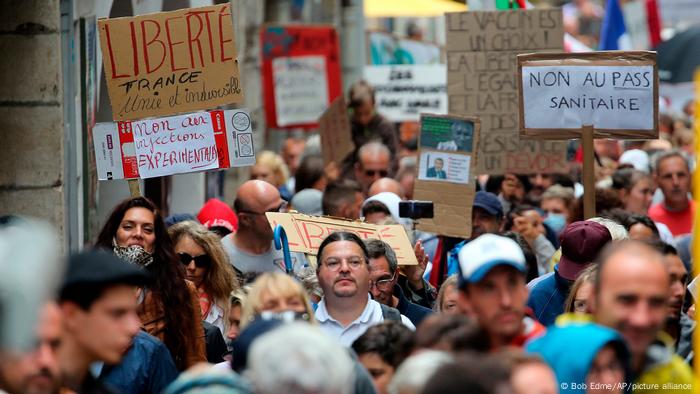  People hold signs reading liberty and no to the sanitary pass during a protest in Bayonne, southwestern France