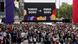 A crowd of people stand in front of a large screen showing Tokyo 2020 and Paris 2024 A crowd of people stand in front of a large screen showing Tokyo 2020 and Paris 2024