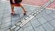 A woman steps over markings on the ground showing the former path of the Berlin Wall A woman steps over markings on the ground showing the former path of the Berlin Wall