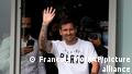 Lionel Messi waves after arriving at Le Bourget airport, north of Paris, Tuesday, Aug. 10, 2021. Lionel Messi finalized agreement on his Paris Saint-Germain contract and was flying to France on Tuesday to complete the move that confirms the end of a career-long association with Barcelona. (AP Photo/Francois Mori)