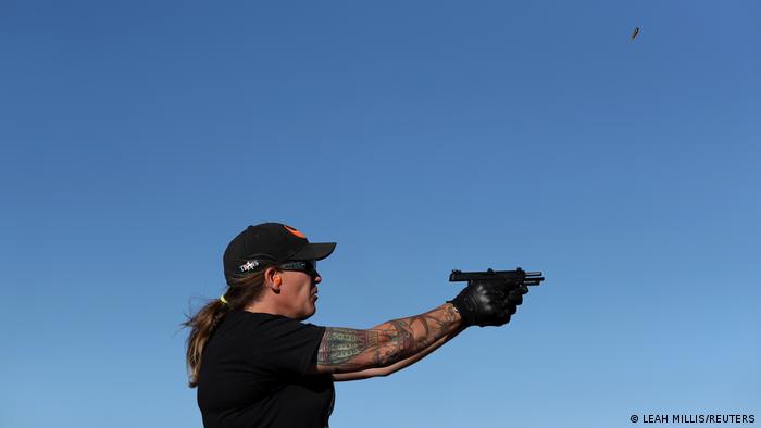 Penny Logue fires her pistol during target practice at a range on the Tenacious Unicorn Ranch in Westcliffe, Colorado, US