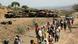 Villagers are seen walking past scores of burned vehicles in south-central Tigray, Ethiopia in 2021