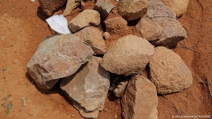 Stones are arranged on a grave where a piece of paper says a soldier from Ethiopia's military is buried in the outskirts of Yechila in Tigray, Ethiopia, July 10, 2021