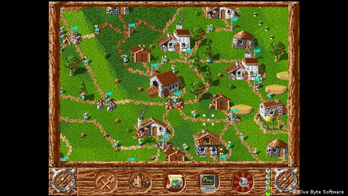 Screenshot Settlers (1993) shows a grassy area dotted with houses and paths and figures walking around 