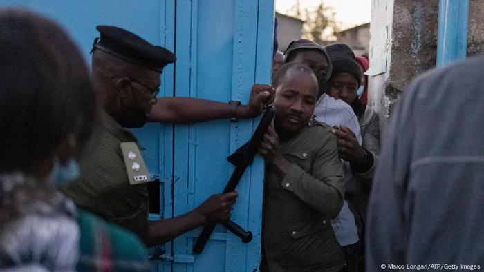 A Zambian policeman tries to control the crowd of voters pushing through the gate of a polling station set up in the Matero secondary school in Lusaka A Zambian policeman tries to control the crowd of voters pushing through the gate of a polling station set up in the Matero secondary school in Lusaka
