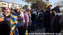 People queue outside a polling station in Lusaka on August 12, 2021 as Zambians elect their next president after a tense campaign dominated by economic woes in Africa's first coronavirus-era sovereign defaulting country. (Photo by Patrick Meinhardt / AFP) (Photo by PATRICK MEINHARDT/AFP via Getty Images)