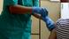 A nurse administers a coronavirus vaccine to a youth A nurse administers a coronavirus vaccine to a youth