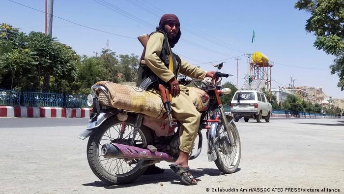 A Taliban fighter poses for a picture after taking control of the key city of Ghanzi, Afghanistan