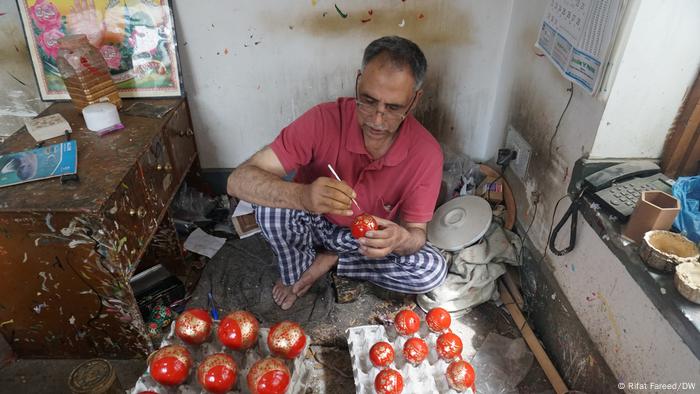 A man paints papier-mache