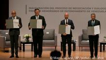 Venezuela's President of the National Assembly Jorge Rodriguez, from left, Mexico’s Foreign Minister Marcelo Ebrard, Norwegian diplomat Dan Nylander and Venezuelan opposition delegate Gerardo Blyde Perez, pose for a photo in Mexico City, Friday, Aug. 13, 2021. The government of Venezuela and its opposition are set to begin a new dialogue this week looking for a change in the South American nation's prolonged political standoff. (AP Photo/Marco Ugarte)