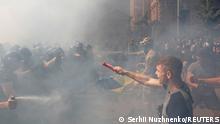 Demonstrators clash with police officers during a protest by activists of the National Corps political party in front of the Presidential Office building in Kyiv, Ukraine August 14, 2021. REUTERS/Serhii Nuzhnenko