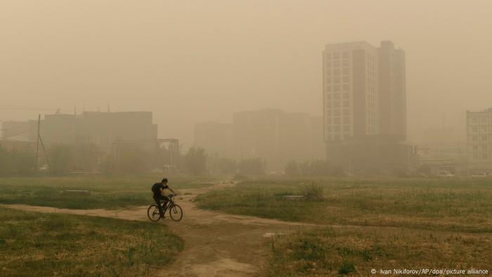 A lone cyclist in smoky Yakutsk in August 2021