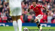 Manchester United's Jadon Sancho runs with the ball during the English Premier League soccer match between Manchester United and Leeds United at Old Trafford in Manchester, England, Saturday, Aug. 14, 2021. (AP Photo/Jon Super)