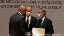 Venezuelan President of the National Assembly Jorge Rodriguez, left, shakes hands with Venezuelan opposition delegate Gerardo Blyde Perez, in Mexico City, Friday, Aug. 13, 2021. The government of Venezuela and its opposition are set to begin a new dialogue this week looking for a change in the South American nation's prolonged political standoff. (AP Photo/Marco Ugarte)