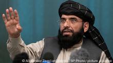 FILE - In this March 19, 2021 file photo, Suhail Shaheen, Afghan Taliban spokesman and a member of the negotiation team gestures while speaking during a joint news conference in Moscow, Russia. In an interview with The Associated Press Thursday, July 22, 2021, Shaheen said the insurgent movement does not want to monopolize power, but there won't be peace until there is a new, negotiated government in Kabul and Afghan President Ashraf Ghani is removed. Shaheen said women will be allowed to work, go to school, and participate in politics but will have to wear the hijab, or headscarf. (AP Photo/Alexander Zemlianichenko, Pool, File)