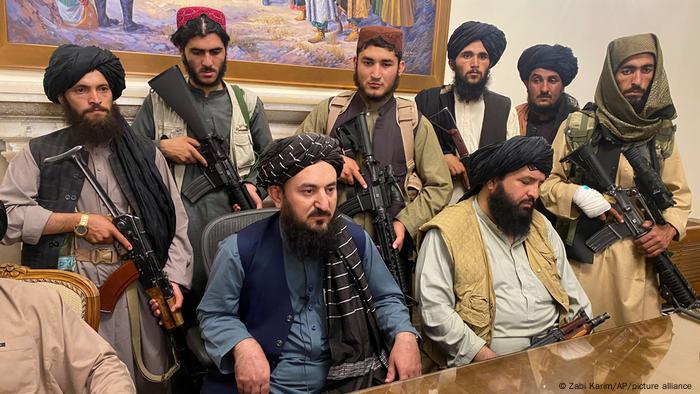 Armed Taliban commanders and fighters sitting inside the presidential palace in Kabul.