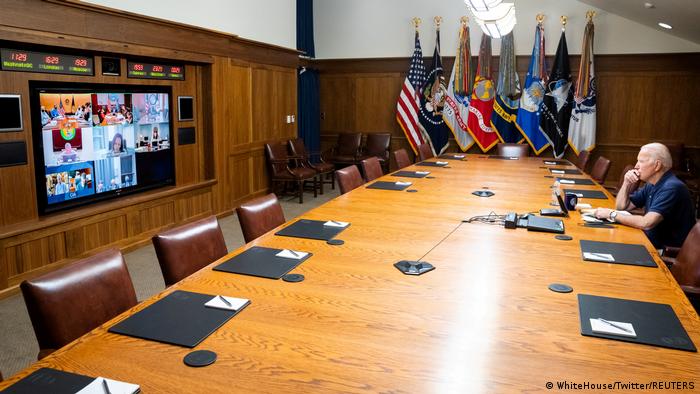 Joe Biden alone at a big table