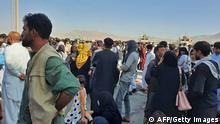 TOPSHOT - Afghans crowd at the tarmac of the Kabul airport on August 16, 2021, to flee the country as the Taliban were in control of Afghanistan after President Ashraf Ghani fled the country and conceded the insurgents had won the 20-year war. (Photo by - / AFP) (Photo by -/AFP via Getty Images)