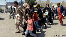 People try to get into Hamid Karzai International Airport in Kabul, Afghanistan August 16, 2021. REUTERS/Stringer NO RESALES. NO ARCHIVES TPX IMAGES OF THE DAY