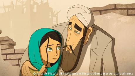 Film still from 'The Breadwinner' - cartoon figures, a young girl with a headscarf embraced by an older man in Afghan dress.