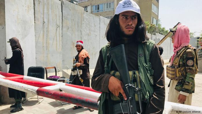 Taliban fighters stand guard at a checkpoint near the US Embassy in Kabul, Afghanistan