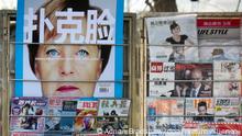 epa03031568 A magazine cover depicting German Chancellor Angela Merkel with the phrase 'Poker Face' looms over a news stand in central Beijing, China, 12 December 2011. China's role in helping the European Union stabilise remains a hotly debated topic both in China and elsewhere. EPA/ADRIAN BRADSHAW ++ +++ dpa-Bildfunk +++