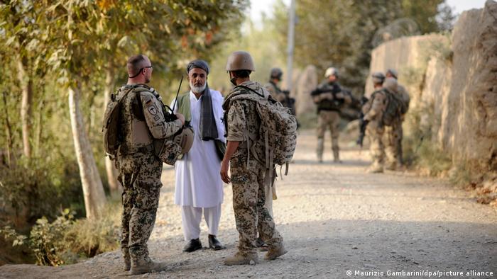 Bundeswehr soldiers talking to an Afghan civilian