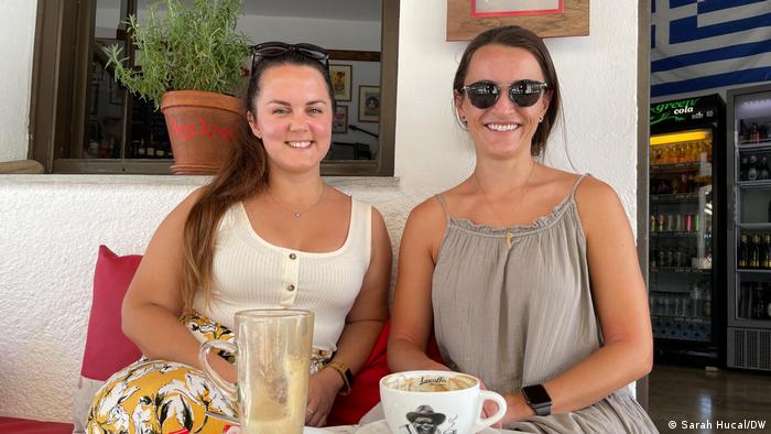 Greece | Two women sitting next to each other at a cafe
