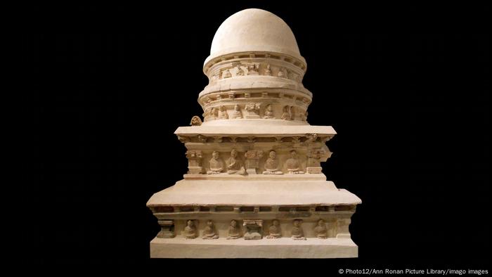 A Buddhist stupa with figures under its multiple eaves