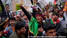 Demonstrators raise their fists during a protest to raise awareness regarding the situation in Afghanistan outside EU headquarters in Brussels, Wednesday, Aug. 18, 2021. The European Union has no immediate plans to recognize the Taliban after their sweeping victory in Afghanistan but will talk with the militants to ensure that European nationals and Afghans who have worked with the EU can leave safely, the bloc's top diplomat said Tuesday. (AP Photo/Francisco Seco)