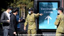 Australian Defense Force personnel assist the public at a COVID-19 vaccination clinic in Sydney, Wednesday, Aug. 18, 2021. Australia's most populous state reported a record 633 new coronavirus infections on Wednesday as concerns grew about the delta variant's spread beyond Sydney. (Dan Himbrechts/AAP Image via AP)