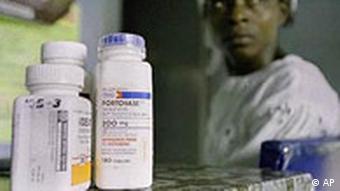AIDS drugs in the foreground and a woman in the background