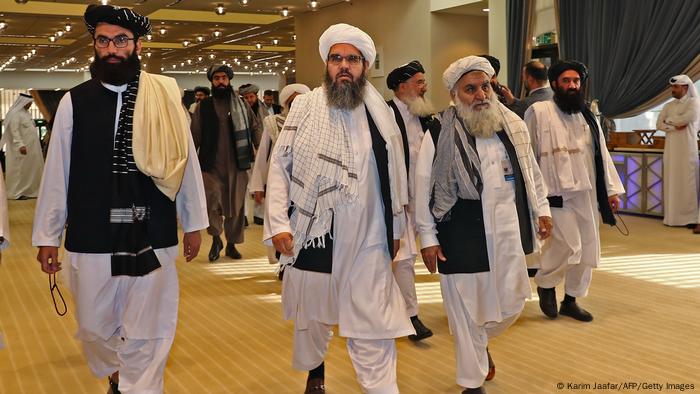 Taliban's former envoy to Saudi Arabia Shahabuddin Delawar (C) and delegate members arrive to the signing of a US-Taliban agreement in the Qatari capital Doha.