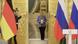 Uniformed guards behind German and Russian flags open large golden doors at the Kremlin in Moscow as then German Chancellor Angela Merkel enters Uniformed guards behind German and Russian flags open large golden doors at the Kremlin in Moscow as then German Chancellor Angela Merkel enters