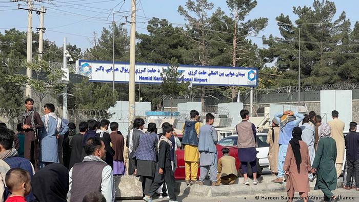 People waiting outside Kabul Airport Friday