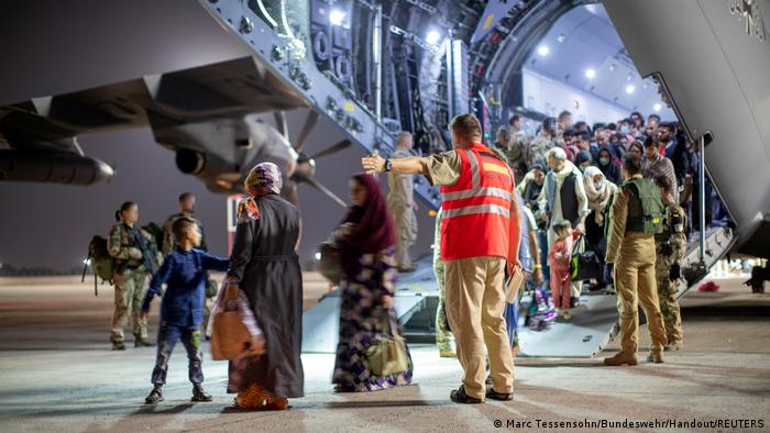 Evacuees from Afghanistan leaving an Airbus A400 transport aircraft of the German Air Force Luftwaffe in Tashkent