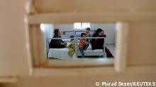A migrant family from Afghanistan, caught by Turkish security forces after crossing illegally into Turkey from Iran, is pictured in a room at a migrant processing centre in the border city of Van, Turkey August 22, 2021. REUTERS/Murad Sezer TPX IMAGES OF THE DAY