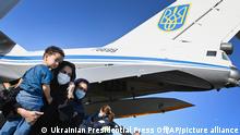 People evacuated from Afghanistan disembark from a Ukrainian military plane at Boryspil International Airport outside Kyiv, Ukraine, Sunday, Aug. 22, 2021. (Ukrainian Presidential Press Office via AP)