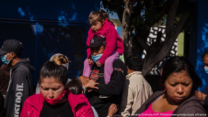 Asylum Seekers wait in line for food in Tijuana, Mexico, Sunday, March 21, 2021