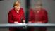 German Chancellor Angela Merkel delivers a speech during a special session of the German parliament Bundestag on Afghanistan in August where she is reflected in glass German Chancellor Angela Merkel delivers a speech during a special session of the German parliament Bundestag on Afghanistan in August where she is reflected in glass