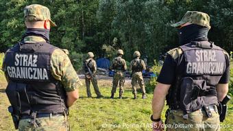 Polish border guards near the tents of Afghan refugees 