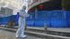 A worker carrying disinfecting equipment walks outside the Wuhan Central Hospital A worker carrying disinfecting equipment walks outside the Wuhan Central Hospital