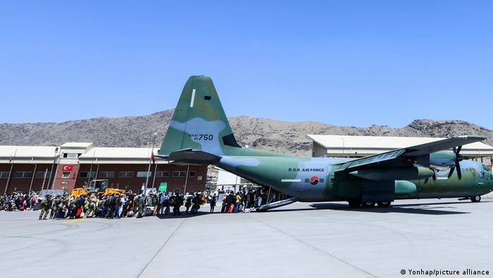 Afghans board a South Korea military plane in Kabul