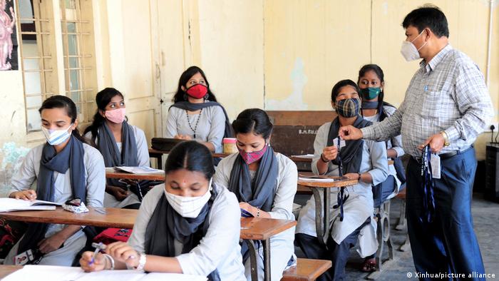 Students attend a class in Bangalore following an 18-month closure
