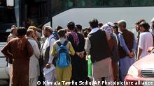 Hundreds of people, some holding documents, gather near an evacuation control checkpoint on the perimeter of the Hamid Karzai International Airport, in Kabul, Afghanistan, Friday, Aug. 27, 2021. (AP Photo/Khwaja Tawfiq Sediqi)