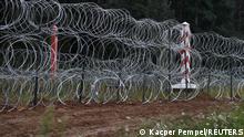 A fence built by Polish soldiers is seen on the border between Poland and Belarus near the village of Nomiki, Poland August 26, 2021. REUTERS/Kacper Pempel