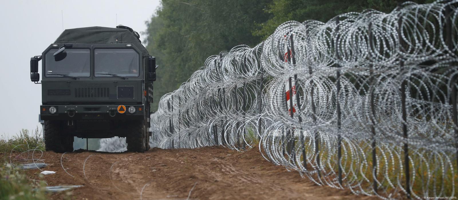 Polish police officers stop cars going in and out of an area along the  border with Belarus, where a state of emergency is in place, in Krynki,  Poland, Wednesday Sept. 29, 2021.