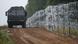 A view of a vehicle next to a fence built by Polish soldiers on the border between Poland and Belarus near the village of Nomiki, Poland August 26, 2021. A view of a vehicle next to a fence built by Polish soldiers on the border between Poland and Belarus near the village of Nomiki, Poland August 26, 2021.
